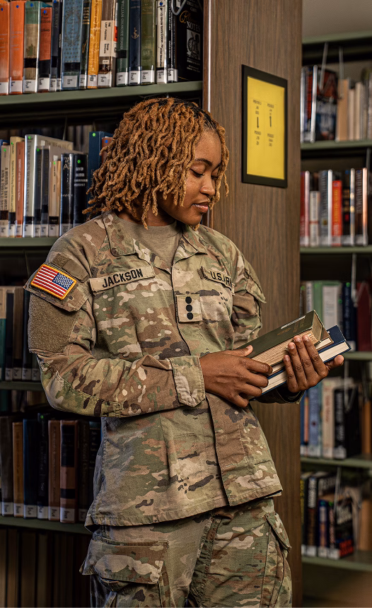 A female cadet in the library stacks