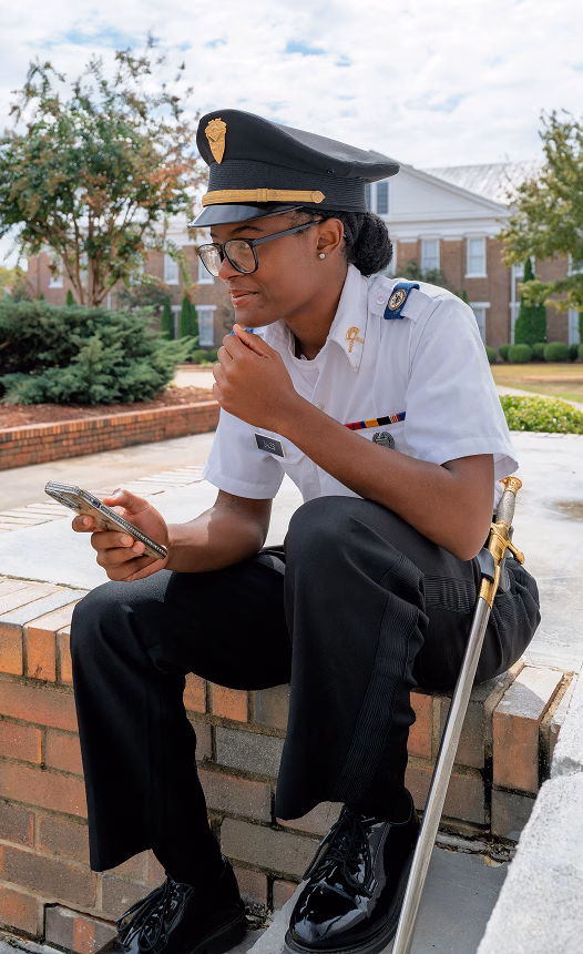 A female cadet checking her phone